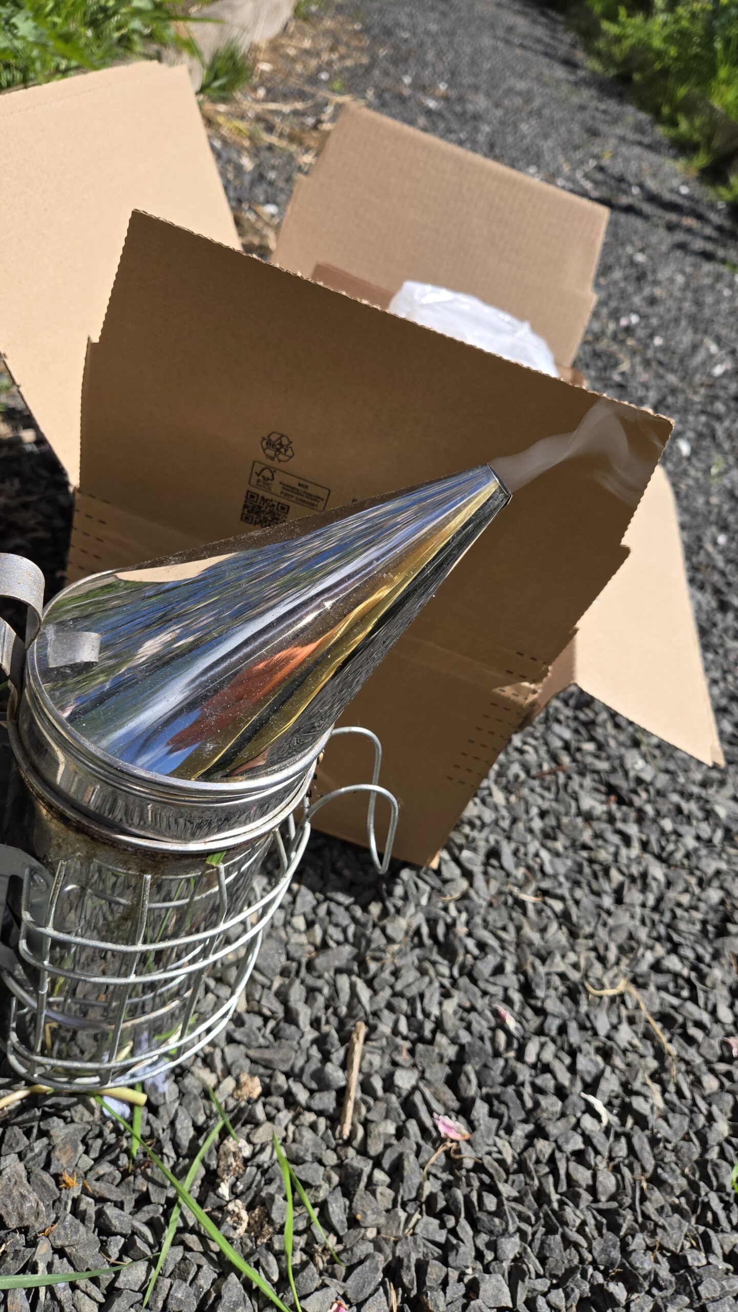 New stainless steel smoker freshly unboxed before the inspection — setup on the day of the queen crossing up.